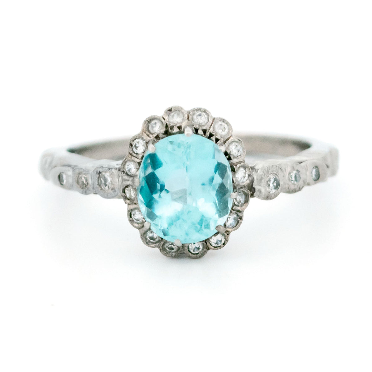 An oval aquamarine and round diamond cluster ring in white gold