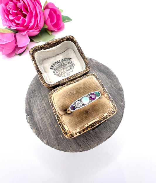 A yellow gold and platinum five stone ring set with amethyst, diamond, opal, ruby and emerald, in an antique ring box