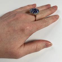 Vintage 8.90ct Sapphire and Diamond Cluster Ring; nine oval sapphires in a floral design, accented with brilliant cut diamonds, in 18ct white and rose gold