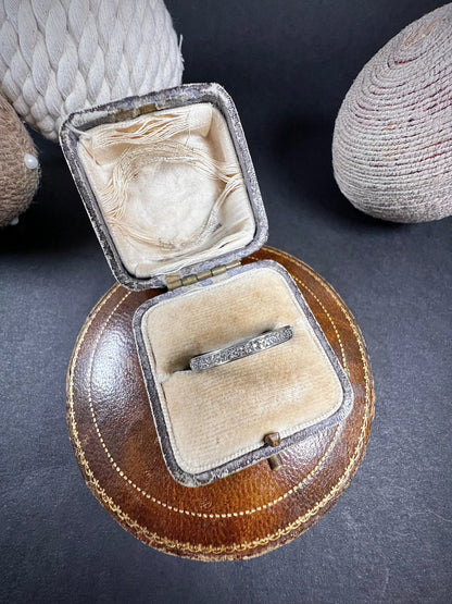 A full eternity ring in white gold, set with diamonds, in a ring box