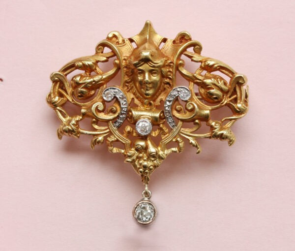 Antique Edwardian Diamond Set 18ct Yellow Gold Neo Renaissance Brooch; openwork Mascaron, scroll, foliate and floral design, Circa 1890.
