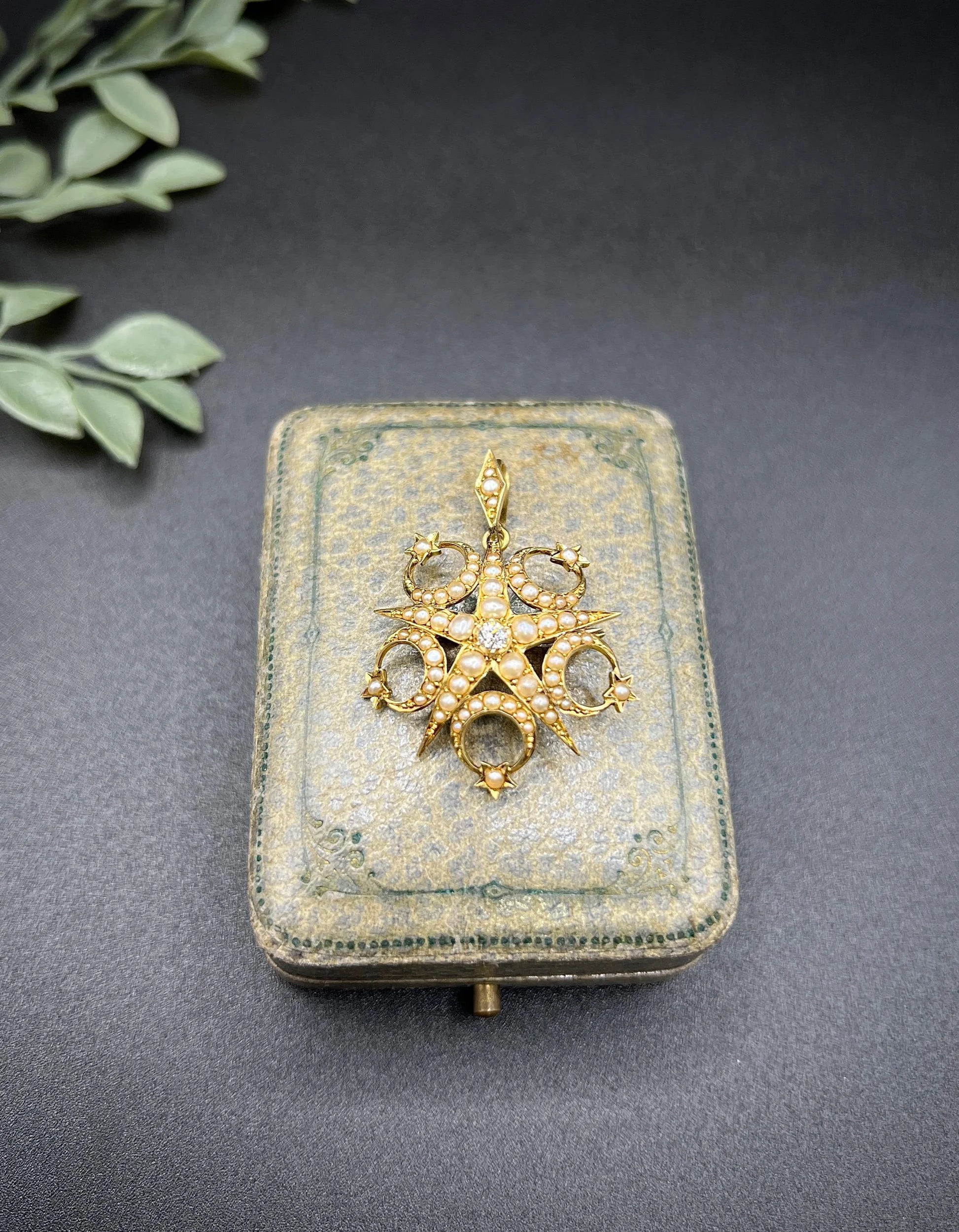 A yellow gold star and crescent brooch/pendant set with a diamond and pearls