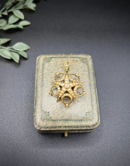 A yellow gold star and crescent brooch/pendant set with a diamond and pearls