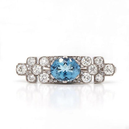 Art Deco Aquamarine, Diamond and Platinum Brooch; vibrant blue oval-cut aquamarine surrounded by 2.50cts old-cut diamonds. Mounted in platinum.