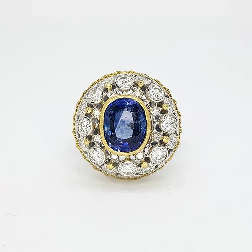 Sapphire and Diamond Cluster Bombe Ring; 2.00ct oval sapphire surrounded by 1.00ct diamond cluster, mounted in 18ct yellow and white gold