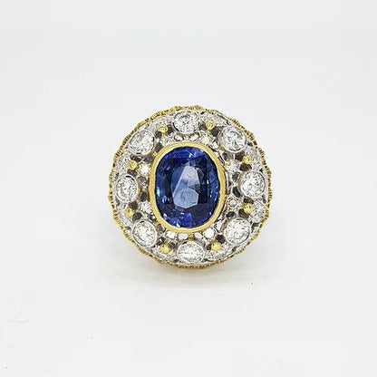 Sapphire and Diamond Cluster Bombe Ring; 2.00ct oval sapphire surrounded by 1.00ct diamond cluster, mounted in 18ct yellow and white gold