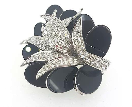 Onyx and Diamond Floral Brooch; central section set with brilliant-cut diamonds, surrounded by eye-catching oval onyx. A spectacular piece.