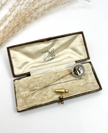 An antique Essex glass and diamond stick pin depicting a jockey riding a horse, in a box
