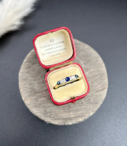 A yellow gold five stone sapphire and diamond carved half hoop ring, in a ring box