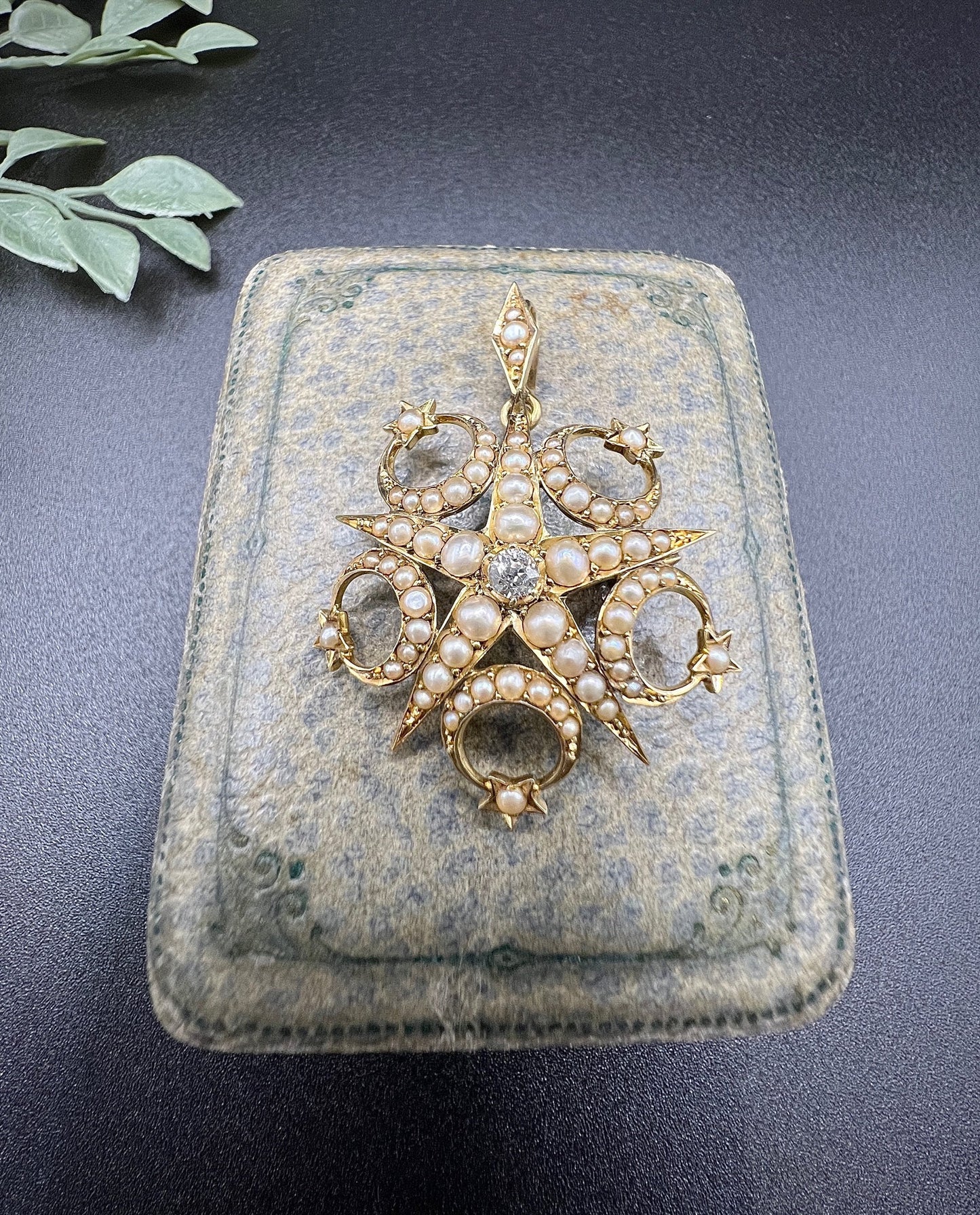 A yellow gold star and crescent brooch/pendant set with a diamond and pearls