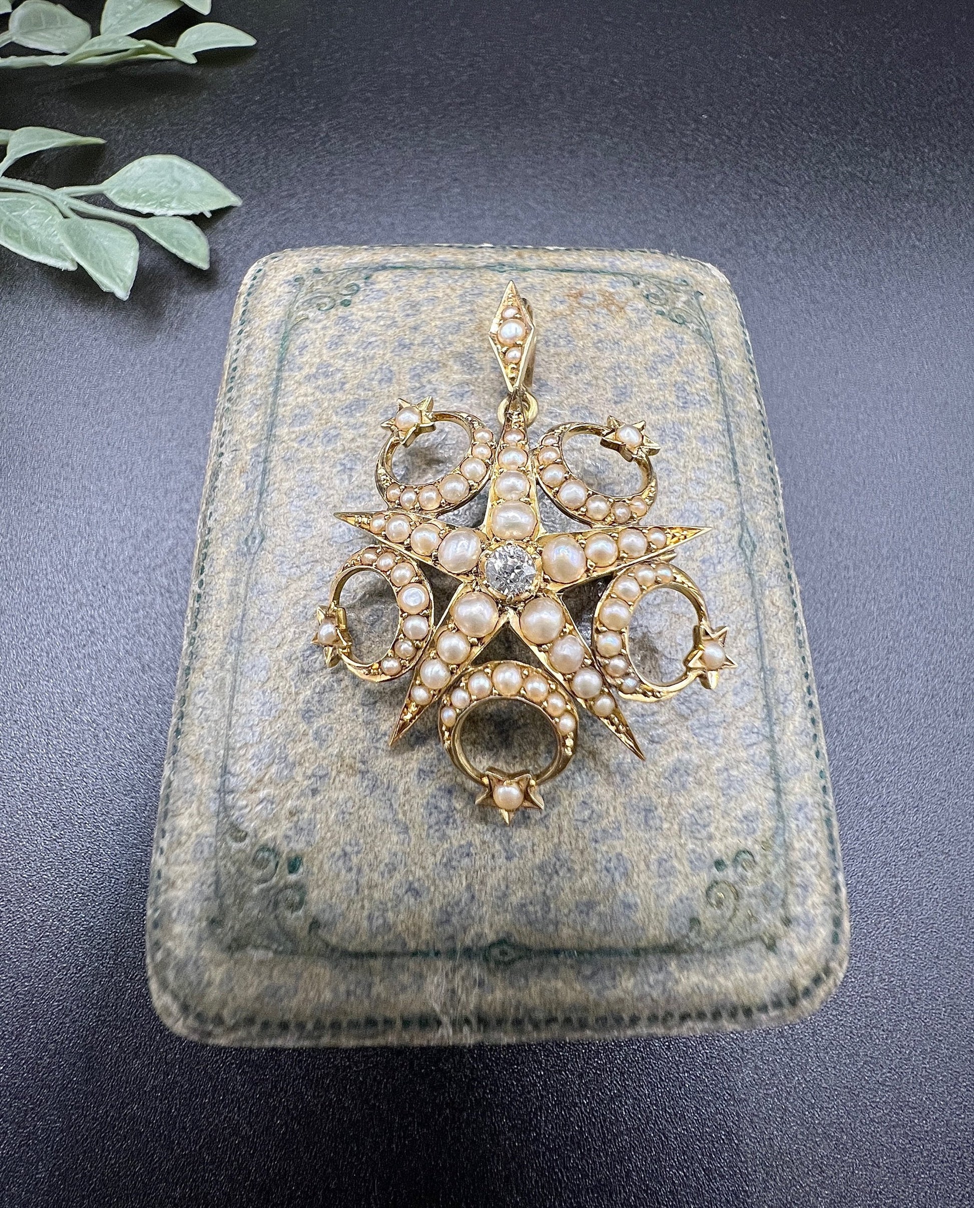 A yellow gold star and crescent brooch/pendant set with a diamond and pearls