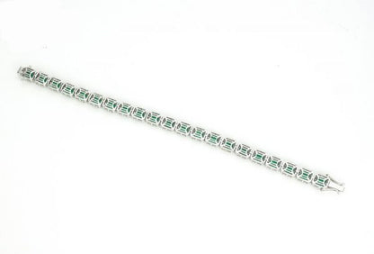 Colombian Emerald and Diamond Cluster Bracelet; featuring 9.02cts emerald-cut emeralds and 3.00cts brilliant cut diamonds, in 14ct White Gold, with certificate