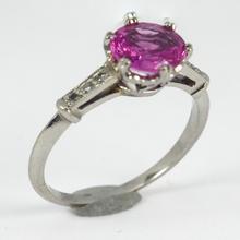 Pink Sapphire, Diamond and Platinum Solitaire Ring; set with a 1.45ct round faceted pink sapphire, with single-cut diamond set shoulders