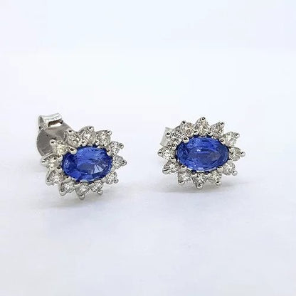 Sapphire and Diamond Oval Cluster Stud Earrings; featuring 1ct oval faceted Sri Lankan blue sapphires set within a cluster of 0.50cts diamonds, in 18ct white gold