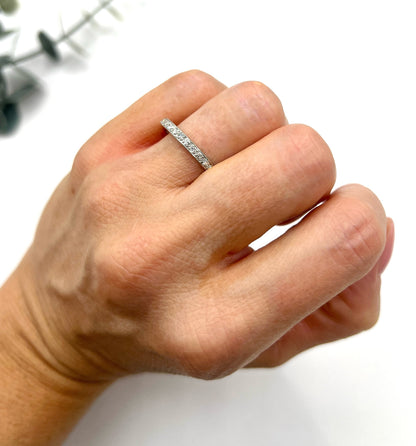 A platinum and diamond full eternity band ring, modelled on a hand