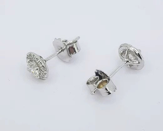 Diamond Cluster Stud Earrings; central brilliant cut diamonds, four-claw set, surrounded by a halo of diamonds, 0.94 carats, 18ct white gold
