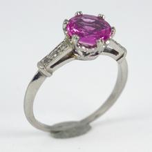 Pink Sapphire, Diamond and Platinum Solitaire Ring; set with a 1.45ct round faceted pink sapphire, with single-cut diamond set shoulders