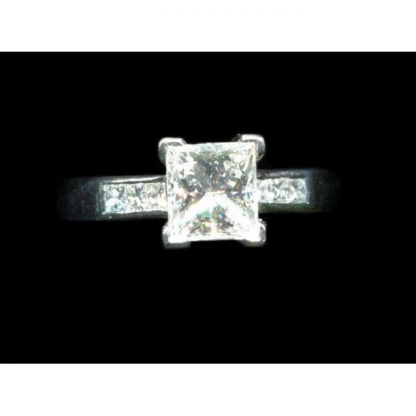 A diamond engagement ring, set with a 1.03 carat, F colour, VS1 clarity, princess-cut diamond, diamond set shoulders, in platinum, with GIA certificate.