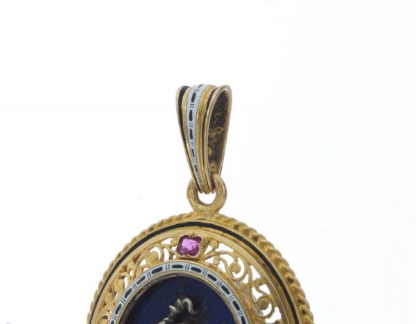 Antique Italian 18ct Yellow Gold Pendant in the style of Castellani; featuring a silver cherub on lapis lazuli, in 18ct pierced surround accented with rubies, Circa 1850-1870s