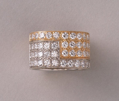 Vintage Diamond and Bi Colour 18ct Gold Band Ring; 18ct yellow and white gold juxtaposed angle pavé set with 48 brilliant cut diamonds, 2.50 carat total, by the Swiss master jeweller Paul Binder. Circa 1970s, Zurich, Switzerland