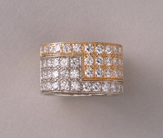 Vintage Diamond and Bi Colour 18ct Gold Band Ring; 18ct yellow and white gold juxtaposed angle pavé set with 48 brilliant cut diamonds, 2.50 carat total, by the Swiss master jeweller Paul Binder. Circa 1970s, Zurich, Switzerland