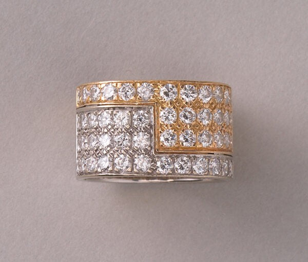 Vintage Diamond and Bi Colour 18ct Gold Band Ring; 18ct yellow and white gold juxtaposed angle pavé set with 48 brilliant cut diamonds, 2.50 carat total, by the Swiss master jeweller Paul Binder. Circa 1970s, Zurich, Switzerland