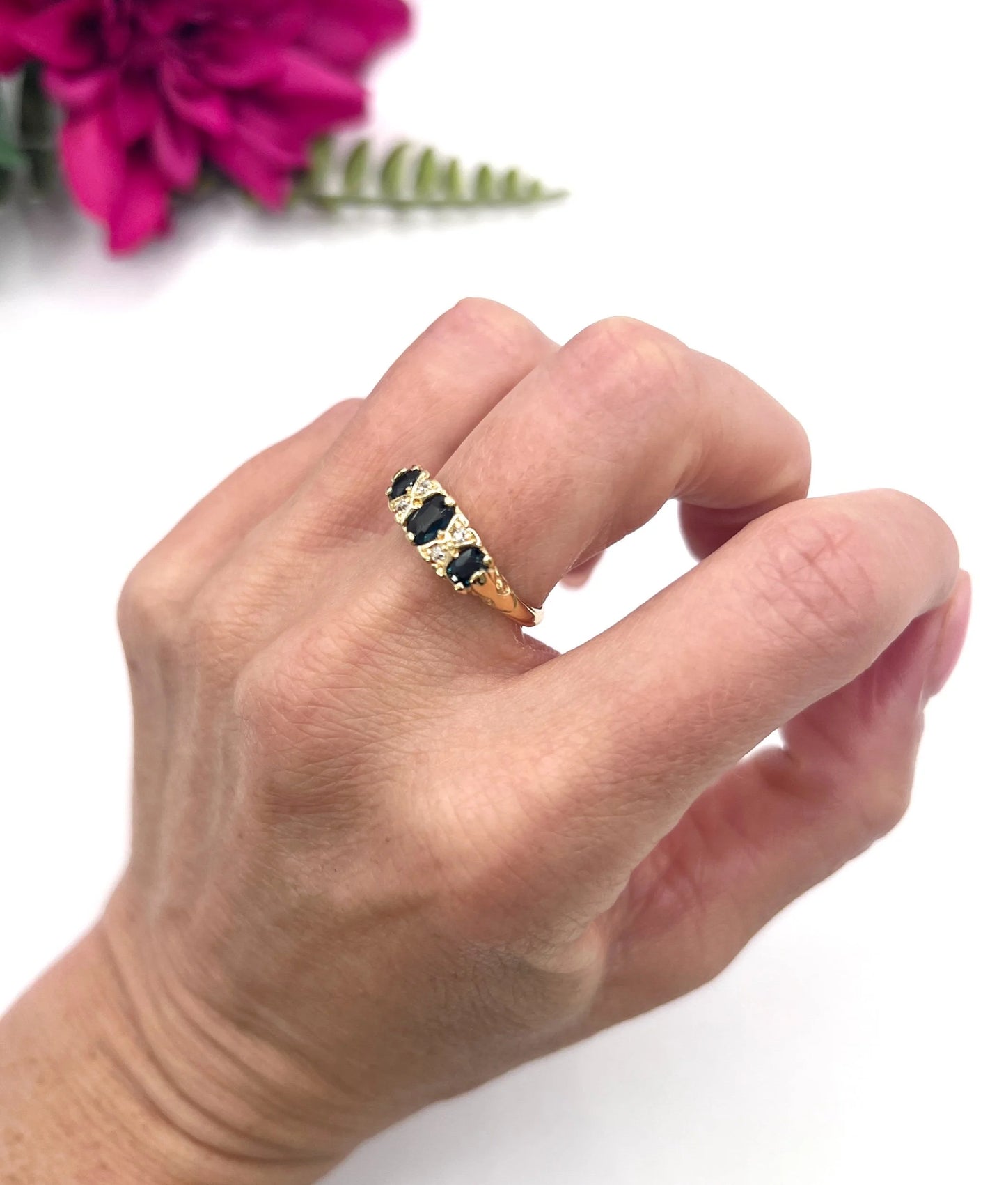 A seven stone sapphire and diamond carved ring in yellow gold, modelled on a hand