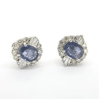 Contemporary Sapphire and Diamond Cluster Earrings; featuring 2.30cts oval faceted sapphires within 1.11ct baguette and brilliant-cut diamond surround, in 18ct white gold