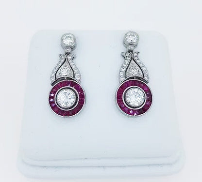 Ruby and Diamond Cluster Drop Earrings; diamond and ruby circular cluster, diamond set scrolls, suspended from diamond stud, 18ct white gold