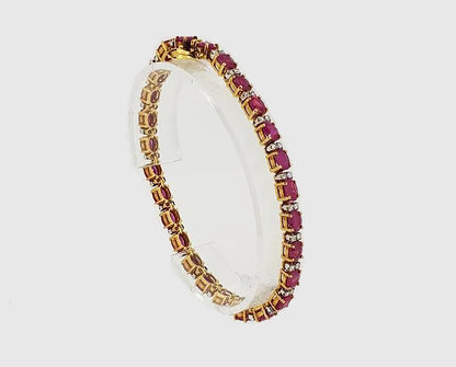Ruby and Diamond Line Bracelet; 11.12cts oval faceted rubies interspersed with 0.92cts brilliant-cut diamonds, set in 18ct yellow gold, with safety clasp