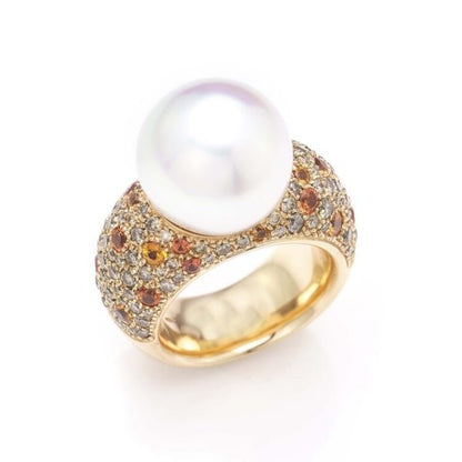 South Sea Pearl, Diamond and Sapphire Cocktail Ring by Schoeffer; 18ct yellow gold domed ring with central high set South Sea pearl, shoulders encrusted with 1.28cts diamonds and 2.72cts orange and yellow sapphires