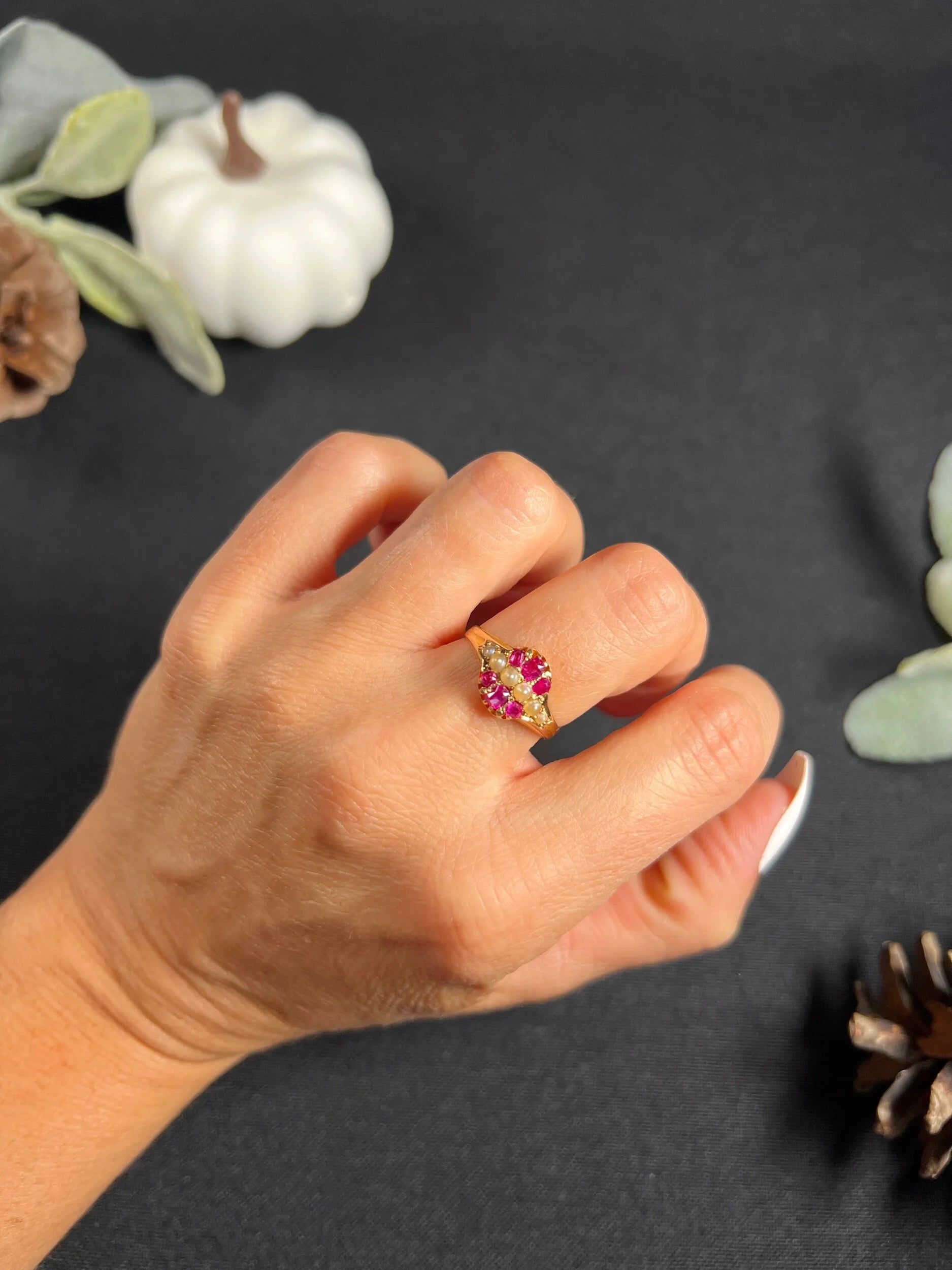 A yellow gold ruby and pearl cluster ring, modelled on a hand