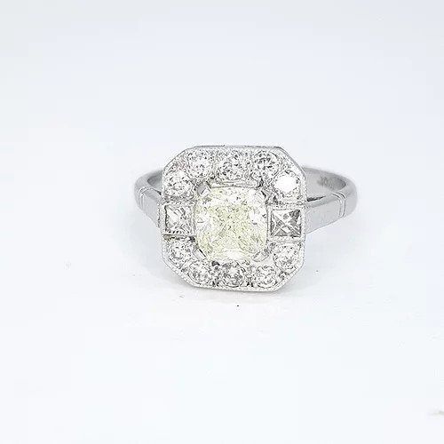 1.03ct Radiant Cut Diamond Cluster Ring; radiant cut diamond surrounded by a halo of diamonds which is accented by square princess-cut diamonds to the shoulders and completed by round-cut diamonds, in 18ct white gold