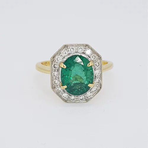 Vintage Natural Colombian Emerald and Diamond Cluster Ring; central 2.50 carat oval faceted natural Colombian emerald surrounded by brilliant-cut diamonds, in 18ct gold, Circa 1970s