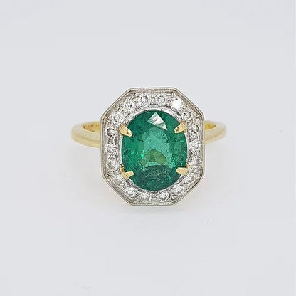 Vintage Natural Colombian Emerald and Diamond Cluster Ring; central 2.50 carat oval faceted natural Colombian emerald surrounded by brilliant-cut diamonds, in 18ct gold, Circa 1970s