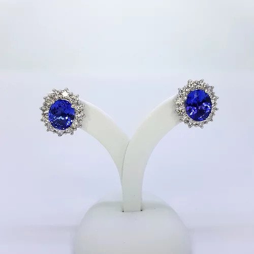 Tanzanite and Diamond Oval Cluster Earrings; 5.20cts oval faceted tanzanites surrounded by 1.76cts round brilliant-cut diamonds, in 18ct white gold