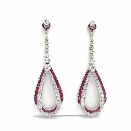 Ruby, Diamond and Platinum Drop Earrings; featuring rows of brilliant-cut diamonds and calibre cut rubies intertwined in a double loop, suspended from a graduated diamond set drop
