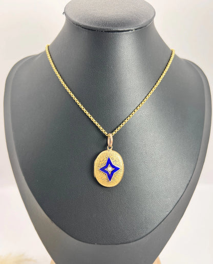 An oval yellow gold locket with a blue enamel star and seed pearl centr, with a chain
