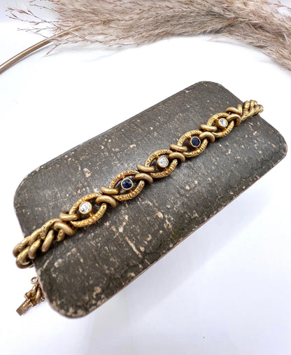 A sapphire and diamond fancy curb link bracelet in yellow gold