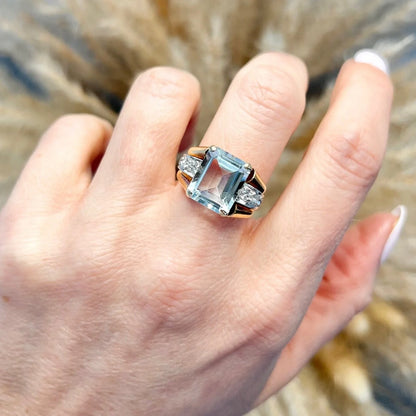 An aquamarine and diamond cocktail ring in gold, modelled on a hand