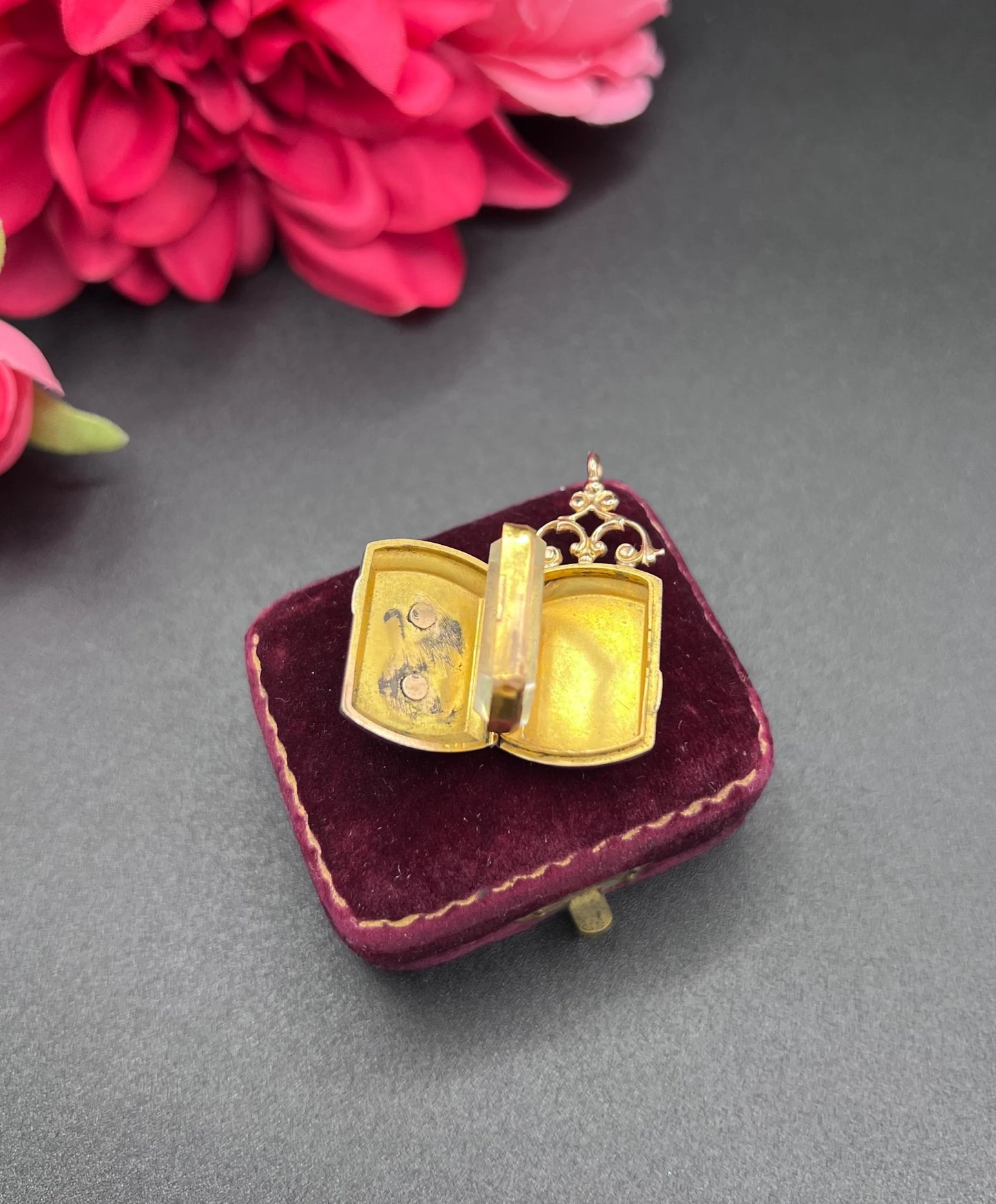 A yellow gold ornate locket with diamond fleur-de-lis detail, open