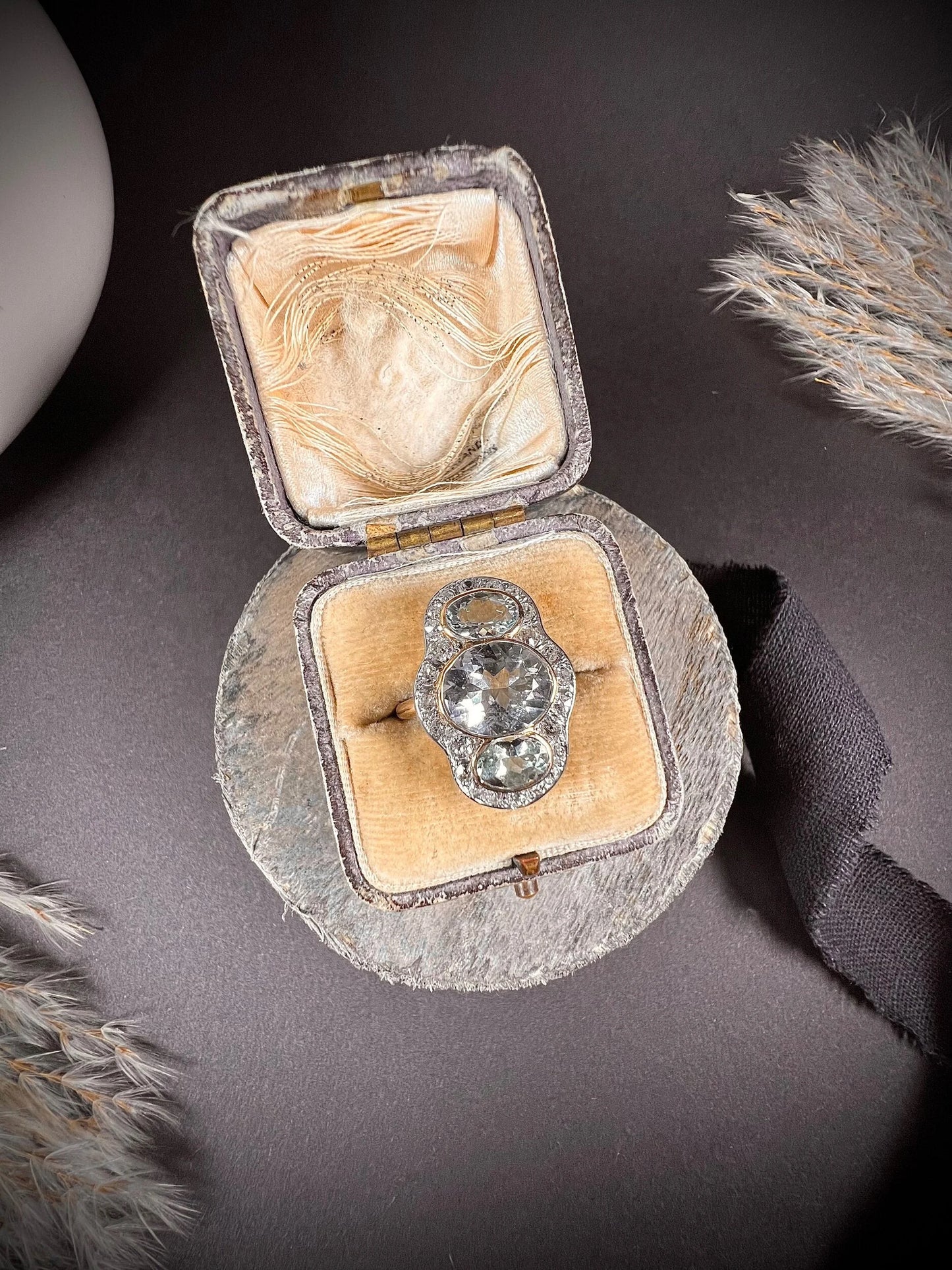 An aquamarine and diamond cocktail cluster ring, in an antique ring box