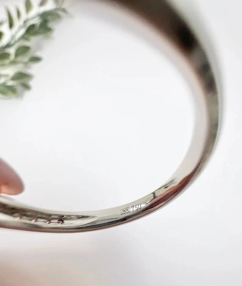 Close-up of an 18K 750 stamp inside a ring shank