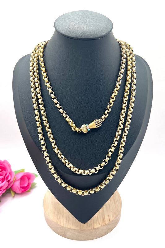 A yellow gold long guard chain with a gem-set hand clasp