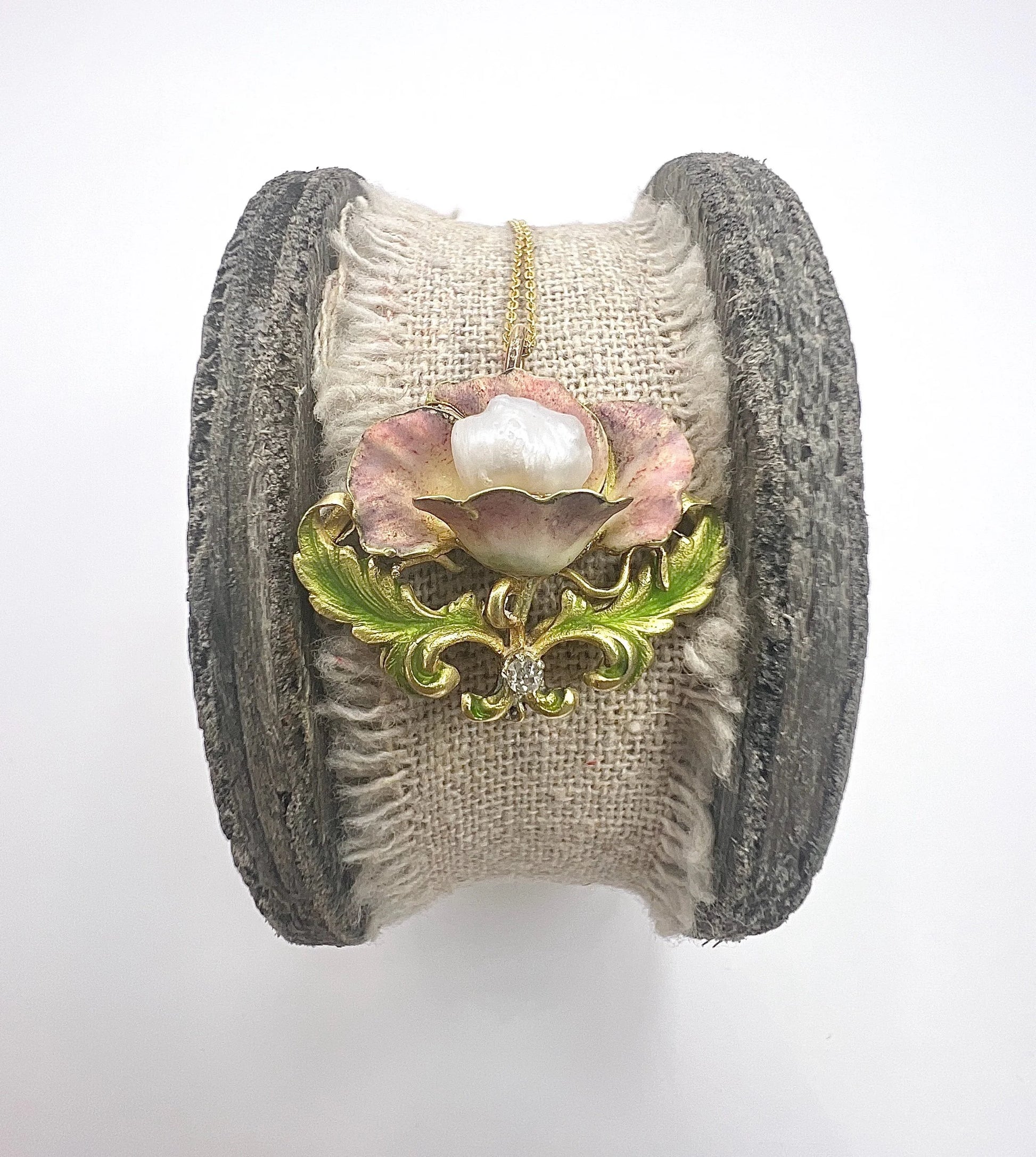 An enamel, diamond and pearl flower pendant with a gold chain