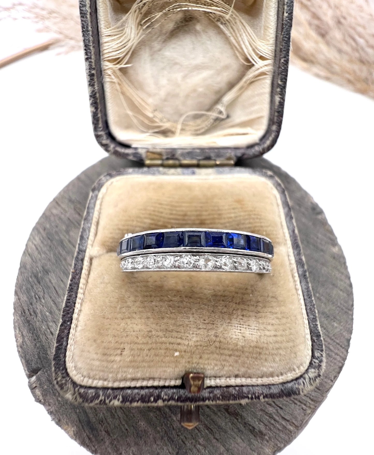 A platinum night and day flip band ring set with diamonds, sapphires and rubies, in a ring box