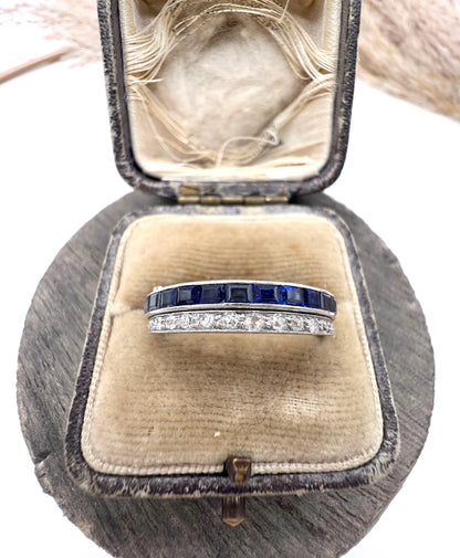 A platinum night and day flip band ring set with diamonds, sapphires and rubies, in a ring box