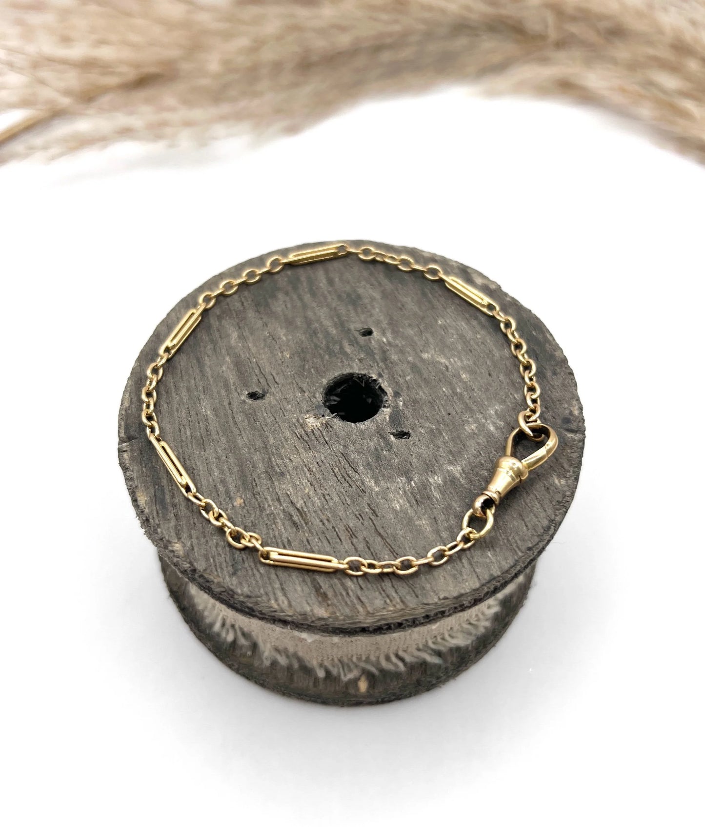 A yellow gold link bracelet with a lobster claw clasp