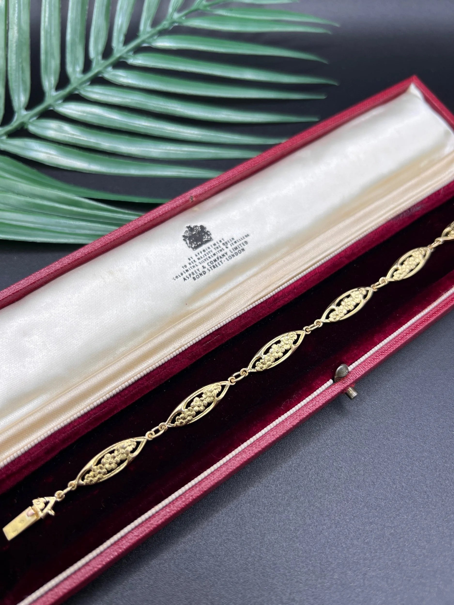 A yellow gold floral link bracelet, in a bracelet box