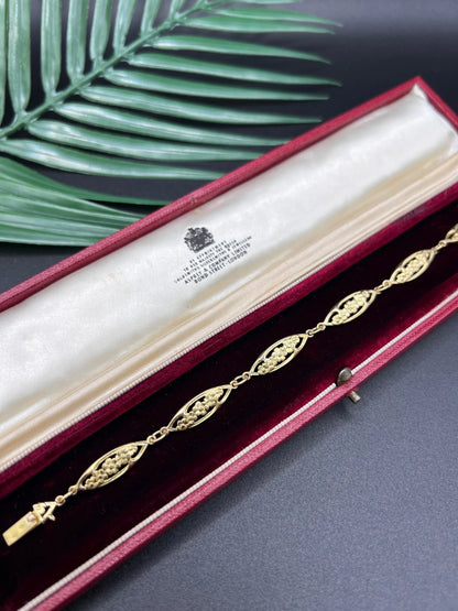 A yellow gold floral link bracelet, in a bracelet box